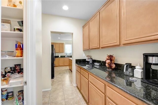 15247 Bandera Way, Victorville, CA 92394 - kitchen featuring freestanding refrigerator, light brown cabinets, light tile patterned floors, dark stone countertops, and recessed lighting