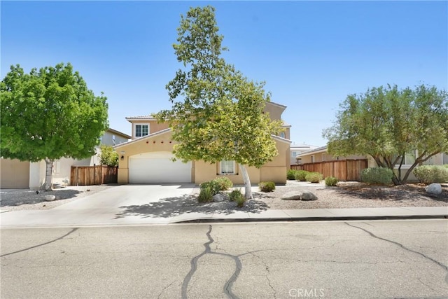 15247 Bandera Way, Victorville, CA 92394 - view of property hidden behind natural elements with stucco siding, driveway, and a garage