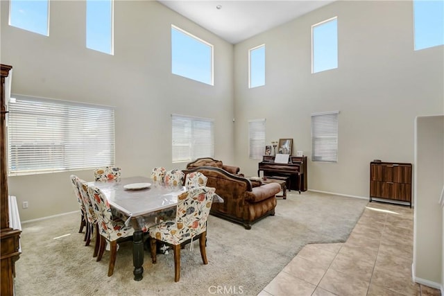 15247 Bandera Way, Victorville, CA 92394 - dining area featuring light colored carpet, a towering ceiling, and light tile patterned floors