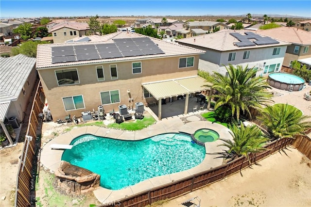 15247 Bandera Way, Victorville, CA 92394 - view of swimming pool featuring a fenced backyard, a residential view, a patio, a diving board, and a pool with connected hot tub