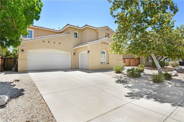 15247 Bandera Way, Victorville, CA 92394 - mediterranean / spanish house featuring stucco siding, driveway, and a garage