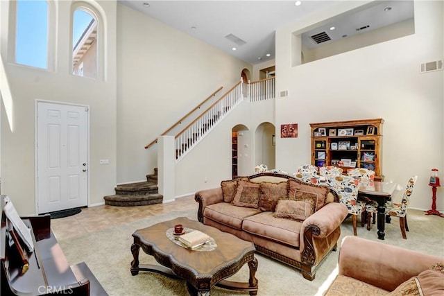15247 Bandera Way, Victorville, CA 92394 - tiled living room with a towering ceiling, arched walkways, recessed lighting, stairway, and carpet