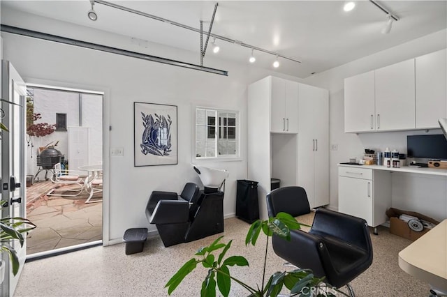 5022 E Broadway, Long Beach, CA 90803 - living room featuring track lighting, dark speckled floor, and a desk
