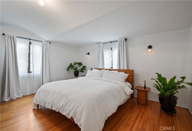 5022 E Broadway, Long Beach, CA 90803 - bedroom featuring multiple windows, light wood-style floors, and vaulted ceiling