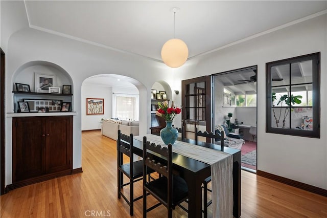 5022 E Broadway, Long Beach, CA 90803 - dining space with healthy amount of natural light, wood finished floors, arched walkways, and crown molding