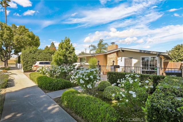 1305 W Beverly Dr, Orange, CA 92868 - view of front of property featuring stucco siding and a chimney