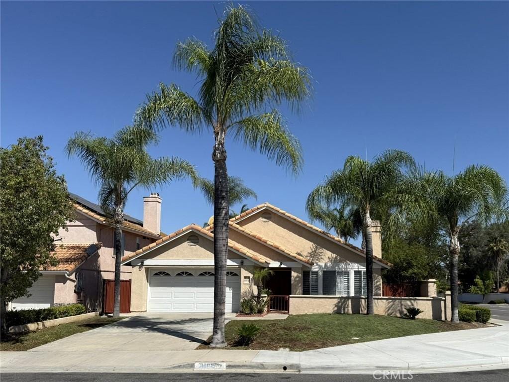 40015 Festival Rd, Murrieta, CA 92562 - view of front of house featuring driveway, stucco siding, an attached garage, and a tiled roof