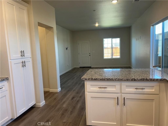 60 Sedona Dr, Merced, CA 95341 - kitchen with dark wood-type flooring, white cabinetry, light stone countertops, healthy amount of natural light, and recessed lighting