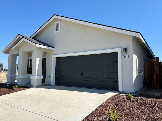 60 Sedona Dr, Merced, CA 95341 - view of front of house featuring stucco siding, a garage, and driveway