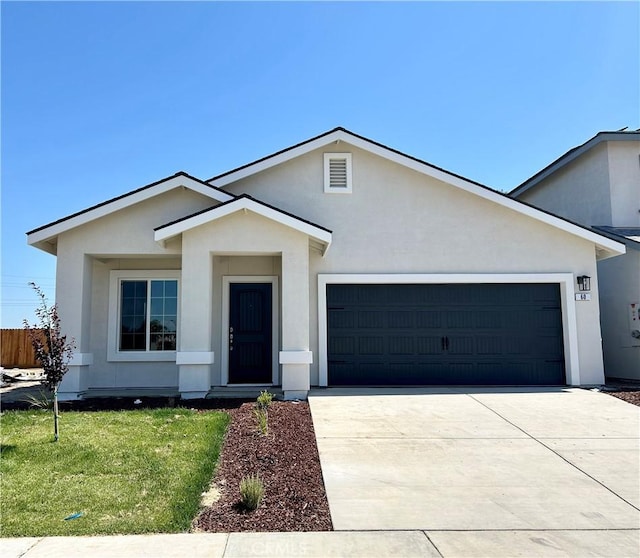 60 Sedona Dr, Merced, CA 95341 - ranch-style house featuring a garage, stucco siding, concrete driveway, and a front lawn
