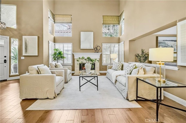 24676 Vista Cerritos, Calabasas, CA 91302 - living room with a towering ceiling, a tile fireplace, and wood-type flooring