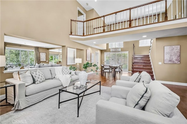 24676 Vista Cerritos, Calabasas, CA 91302 - living room with stairs, a high ceiling, healthy amount of natural light, wood finished floors, and recessed lighting