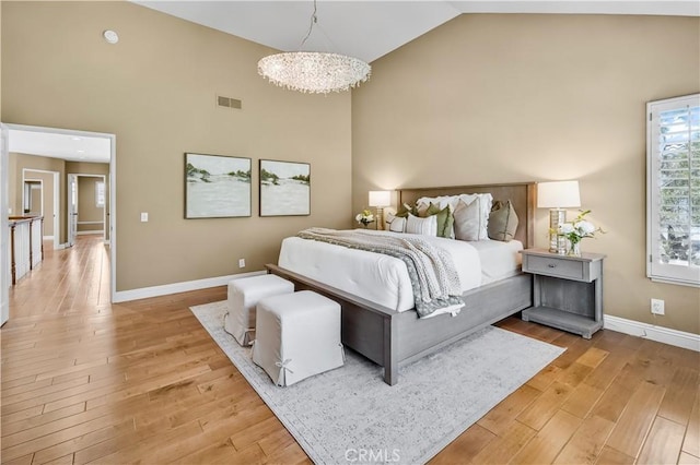 24676 Vista Cerritos, Calabasas, CA 91302 - bedroom with high vaulted ceiling, light wood finished floors, and a chandelier