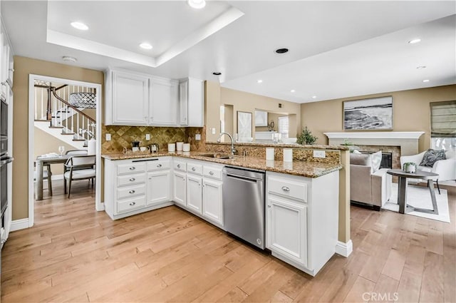24676 Vista Cerritos, Calabasas, CA 91302 - kitchen with stainless steel dishwasher, a peninsula, open floor plan, light wood-type flooring, and recessed lighting