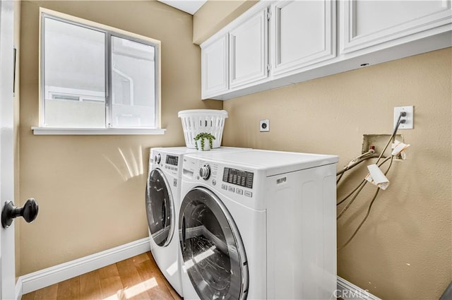 24676 Vista Cerritos, Calabasas, CA 91302 - laundry area featuring separate washer and dryer, light wood-type flooring, and cabinet space