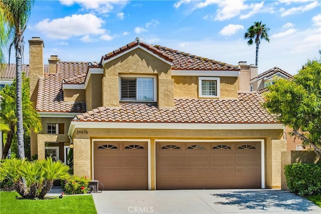 24676 Vista Cerritos, Calabasas, CA 91302 - mediterranean / spanish home with driveway, stucco siding, a tile roof, an attached garage, and a chimney