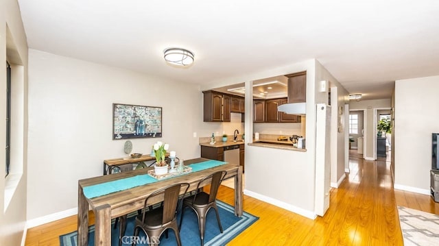 8800 Garden Grove Blvd Unit 2, Garden Grove, CA 92844 - dining space with light wood-style flooring and baseboards