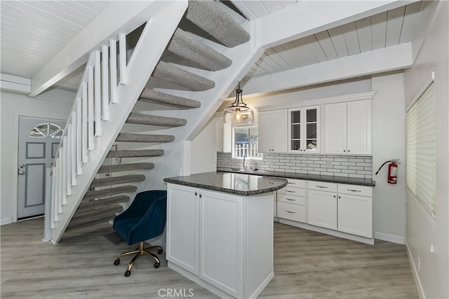 776 Lords Ln, Lake Arrowhead, CA 92352 - kitchen featuring tasteful backsplash, white cabinetry, glass insert cabinets, light wood finished floors, and a wood ceiling with exposed beams