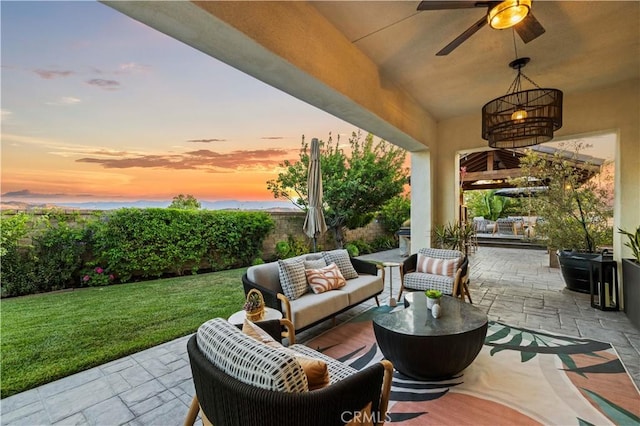 22388 Riverstream Ct, Saugus, CA 91350 - patio terrace at dusk featuring an outdoor living space, ceiling fan, a patio, and a yard