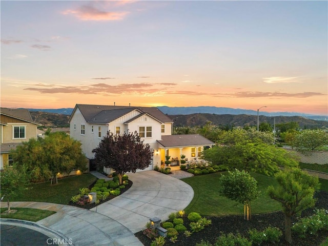 22388 Riverstream Ct, Saugus, CA 91350 - view of front of property featuring curved driveway, a tile roof, a mountain view, a yard, and stucco siding