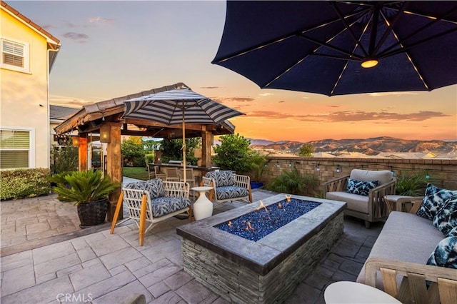 22388 Riverstream Ct, Saugus, CA 91350 - patio terrace at dusk with an outdoor fire pit and a patio