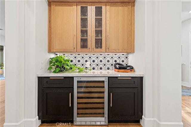 22388 Riverstream Ct, Saugus, CA 91350 - bar featuring wine cooler and backsplash