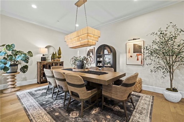 22388 Riverstream Ct, Saugus, CA 91350 - dining area with arched walkways, wood finished floors, ornamental molding, and recessed lighting