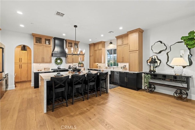 22388 Riverstream Ct, Saugus, CA 91350 - kitchen featuring custom range hood, black dishwasher, a kitchen island, light wood finished floors, and recessed lighting