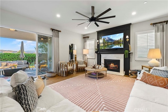 22388 Riverstream Ct, Saugus, CA 91350 - living room featuring a ceiling fan, recessed lighting, wood finished floors, and a glass covered fireplace