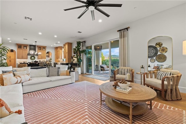 22388 Riverstream Ct, Saugus, CA 91350 - living area with a ceiling fan, arched walkways, recessed lighting, light wood-style flooring, and a chandelier