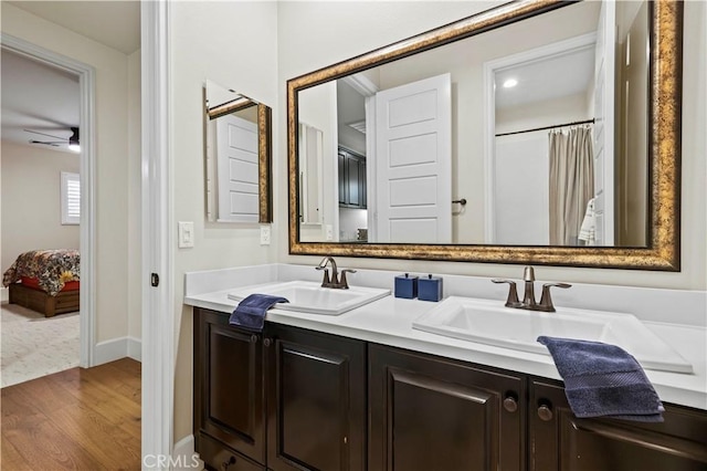 22388 Riverstream Ct, Saugus, CA 91350 - ensuite bathroom with double vanity, wood finished floors, and ceiling fan
