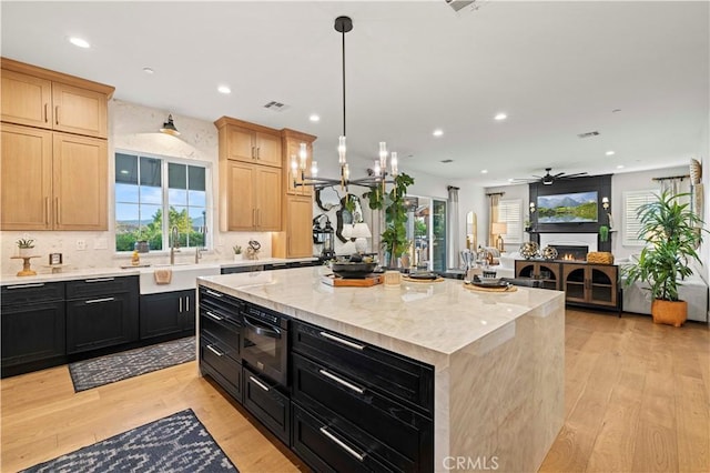 22388 Riverstream Ct, Saugus, CA 91350 - kitchen with dark cabinets, light wood-type flooring, recessed lighting, light brown cabinets, and a ceiling fan