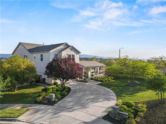 22388 Riverstream Ct, Saugus, CA 91350 - view of front of home with curved driveway, a front lawn, a mountain view, and a tile roof