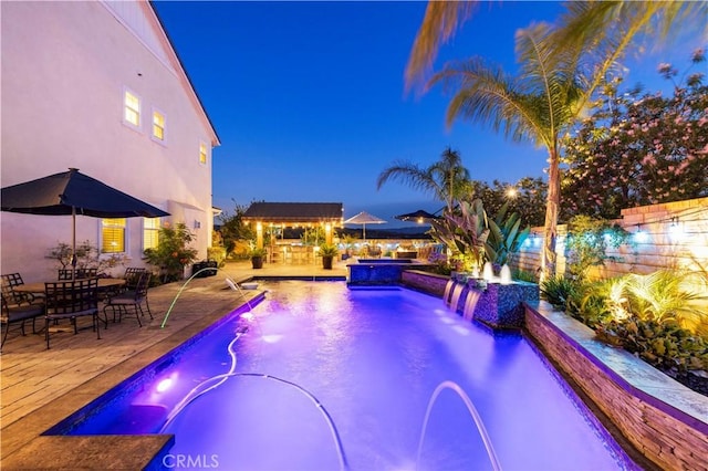 22388 Riverstream Ct, Saugus, CA 91350 - pool at night with a pool with connected hot tub and a patio area