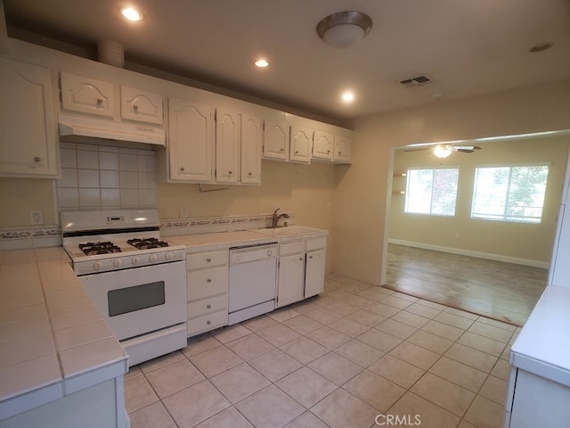 22727 Mariano St, Woodland Hills, CA 91367 - kitchen with white appliances, under cabinet range hood, tile counters, white cabinetry, and recessed lighting