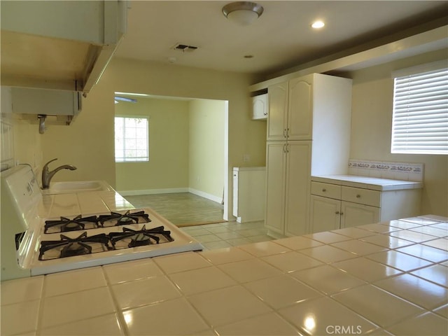 22727 Mariano St, Woodland Hills, CA 91367 - kitchen featuring tile counters, stove, recessed lighting, white cabinets, and light tile patterned floors