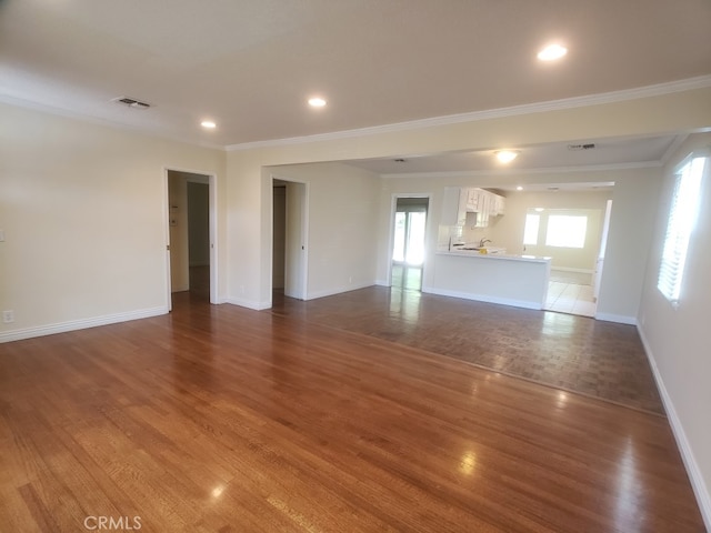 22727 Mariano St, Woodland Hills, CA 91367 - unfurnished living room featuring ornamental molding, wood finished floors, and recessed lighting