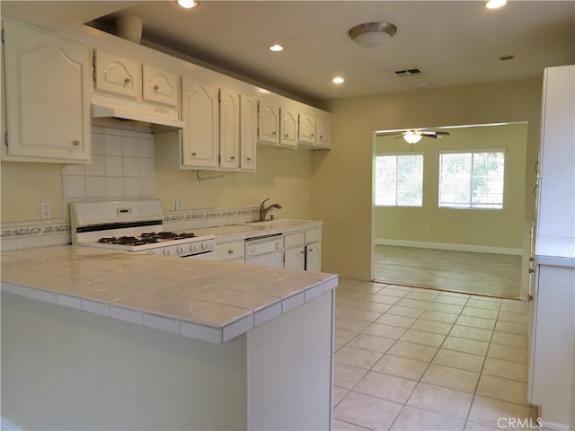 22727 Mariano St, Woodland Hills, CA 91367 - kitchen featuring white appliances, under cabinet range hood, tile countertops, a ceiling fan, and a peninsula
