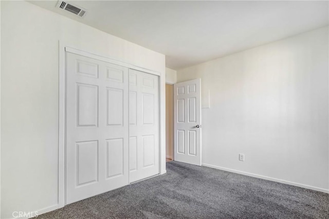 1265 Kendall Dr Unit 222, San Bernardino, CA 92407 - unfurnished bedroom with dark carpet and a closet
