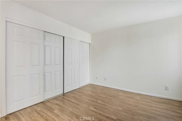 1265 Kendall Dr Unit 222, San Bernardino, CA 92407 - unfurnished bedroom with light wood-style floors and a closet