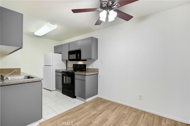 1265 Kendall Dr Unit 222, San Bernardino, CA 92407 - kitchen with black appliances, gray cabinets, light wood-style floors, a ceiling fan, and light countertops