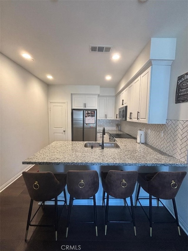 2717 Juniper Berry St, Spring Valley, CA 91977 - kitchen with smart refrigerator, stainless steel microwave, a peninsula, white cabinetry, and recessed lighting