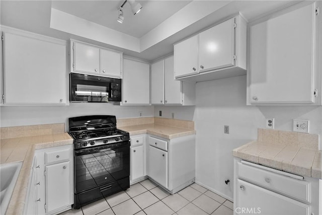 2231 Pacific Ave Unit 14, Costa Mesa, CA 92627 - kitchen with black appliances, white cabinets, and light tile patterned flooring
