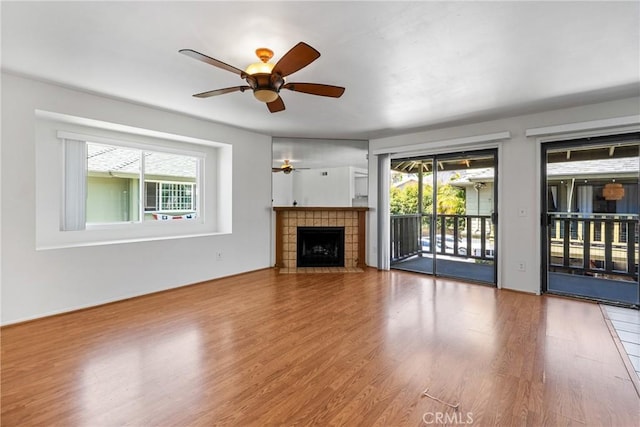 2231 Pacific Ave Unit 14, Costa Mesa, CA 92627 - unfurnished living room with a ceiling fan, wood finished floors, and a tile fireplace