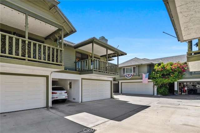 2231 Pacific Ave Unit 14, Costa Mesa, CA 92627 - view of side of property with a garage, driveway, and stucco siding