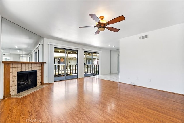 2231 Pacific Ave Unit 14, Costa Mesa, CA 92627 - unfurnished living room with a ceiling fan, a tile fireplace, wood finished floors, and recessed lighting