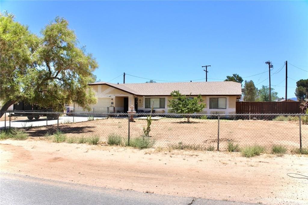 22465 Standing Rock Ave, Apple Valley, CA 92307 - single story home with a fenced front yard, stucco siding, and an attached garage