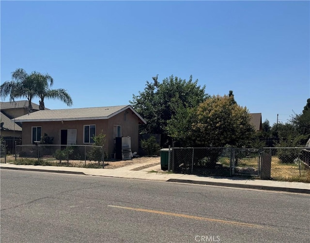 425 S Rose, Farmersville, CA 93223 - view of front facade featuring stucco siding and a gate