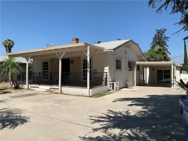 1271 N K St, San Bernardino, CA 92411 - view of front of home featuring driveway, a chimney, and covered porch