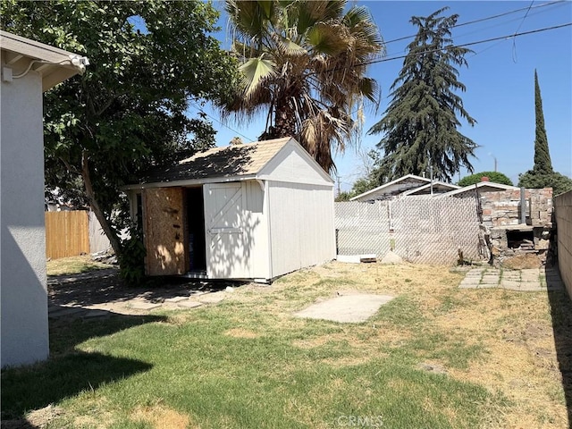 1271 N K St, San Bernardino, CA 92411 - fenced backyard featuring a storage unit